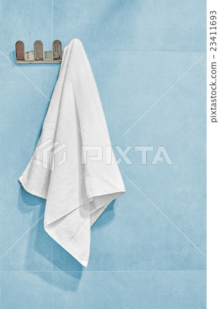 White towel hanging on a wall in bathroom. 23411693