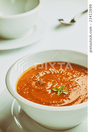 Retro stylized white bowl with tomato soup. 23411699