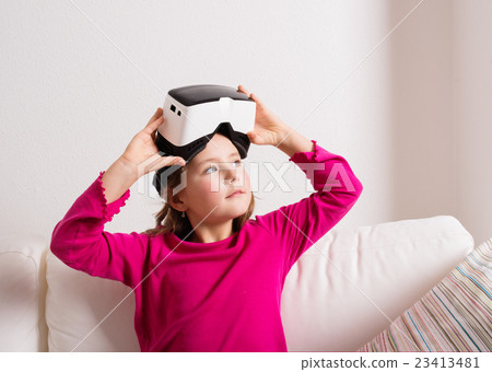 Girl wearing virtual reality goggles. Studio shot 23413481