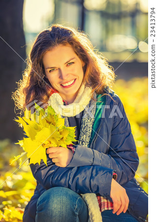 Portrait of young beautiful woman in autumn park Portrait of young beautiful woman in autumn park 23413794