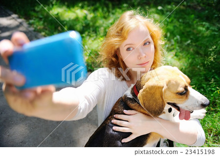 Young hipster woman making selfie photo with Beagle dog Young hipster woman making selfie photo with Beagle dog 23415198