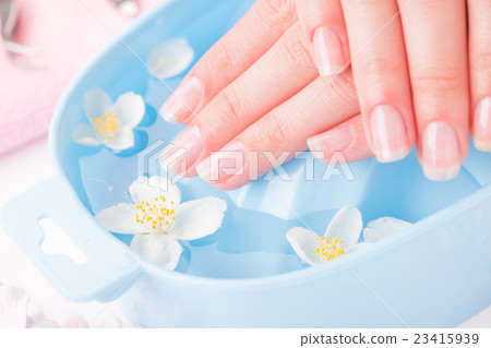 Beautiful woman's hands with manicure in bowl of 23415939