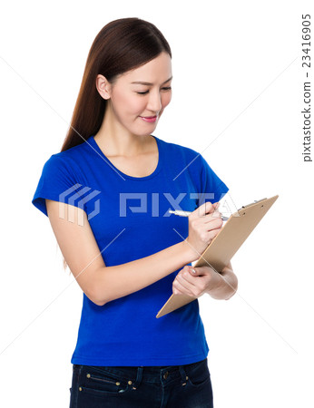 Young woman take note on clipboard Young woman take note on clipboard 23416905