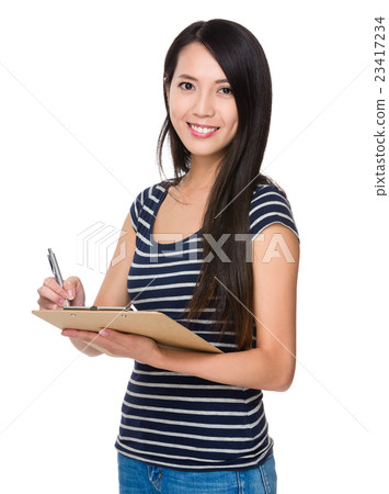 Young Woman take note on clipboard Young Woman take note on clipboard 23417234
