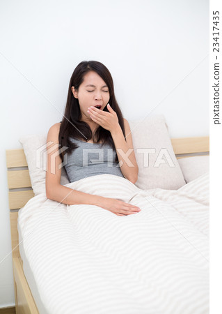 Woman just wake up and yawning on bed 23417435