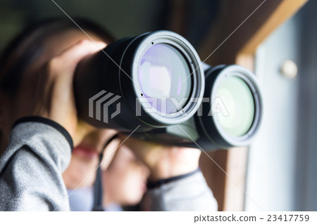 Asian woman looking though binocular 23417759