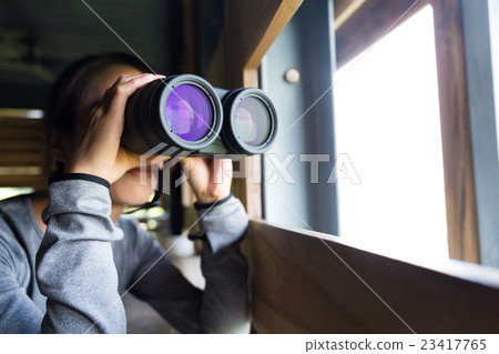 Young woman use of the telescope at wooden house Young woman use of the telescope at wooden house 23417765