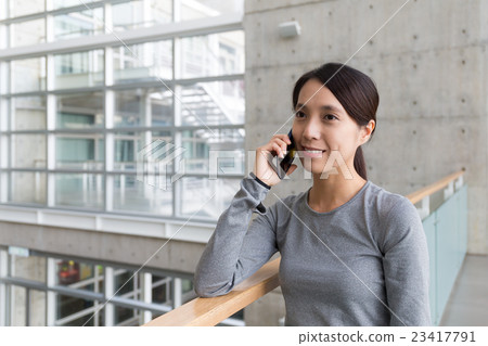 Woman make a call by mobile phone 23417791