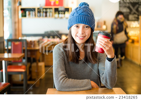 Woman enjoy coffee at cafe 23418265