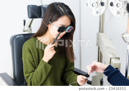 Patient during an eye examination at eye clinic 23418331