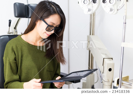 Woman checking sense of three dimensional on eye clinic 23418336