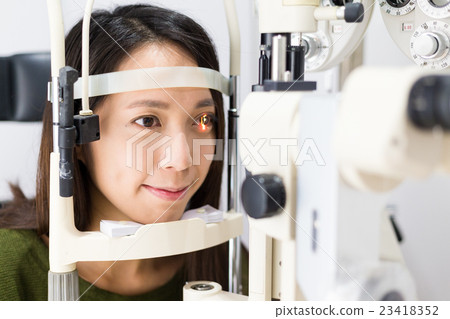 Patient during an eye examination at the eye clinic 23418352