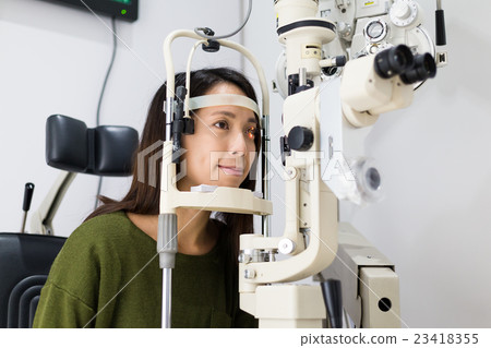 Young woman is having eye exam 23418355