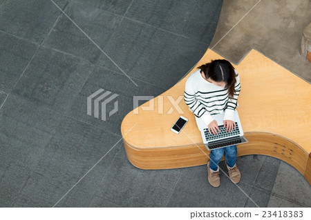 Top view of woman working on laptop computer Top view of woman working on laptop computer 23418383