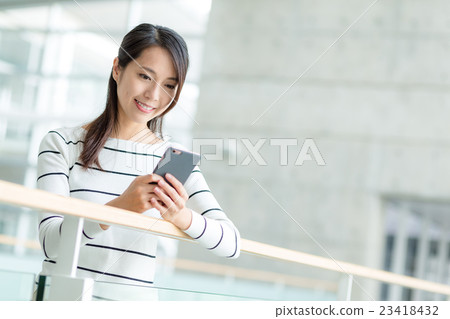 Woman use of mobile phone Woman use of mobile phone 23418432