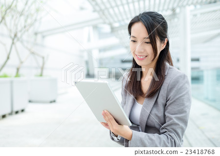 Woman using a digital tablet 23418768