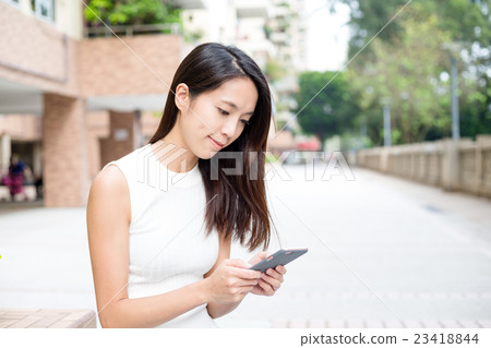 Woman sending sms on smart phone Woman sending sms on smart phone 23418844