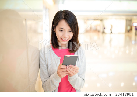 Woman use of mobile phone in shopping mobile 23418991