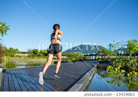 Runner athlete running at park 23419063