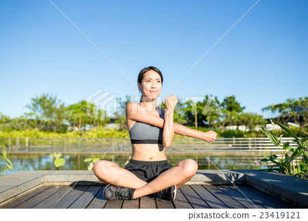 Woman stretching hand at park 23419121