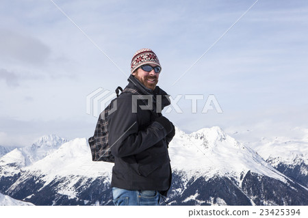 Young man enjoys the view in the mountains Young man enjoys the view in the mountains 23425394