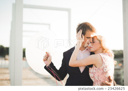 Young couple in love posing on roof with perfect Young couple in love posing on roof with perfect 23426625