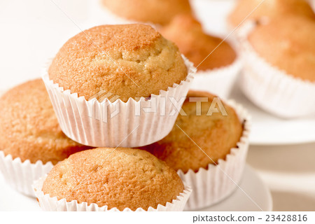 plain muffins on a set table plain muffins on a set table 23428816