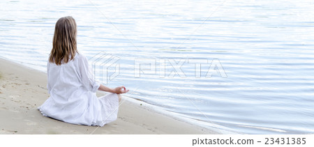 Woman meditating at the sea Woman meditating at the sea 23431385