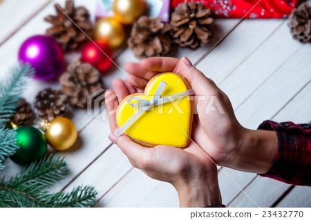 female hands holding a cookie female hands holding a cookie 23432770