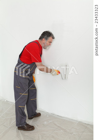 Worker painting  room to white 23433323