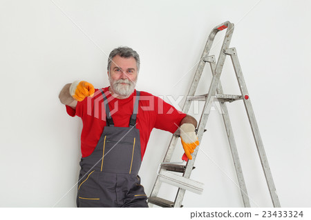 Worker painting  room to white 23433324