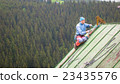 Man Working on the Roof, Checking Safety Gear 23435576