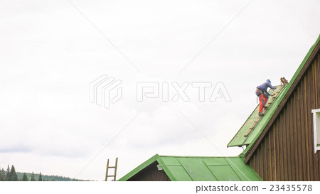Man Working on the Roof, Sandering Paint Man Working on the Roof, Sandering Paint 23435578
