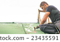 Man Working on the Roof, Sandering Paint 23435591
