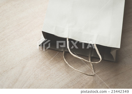 Paper bag on a wooden background Paper bag on a wooden background 23442349