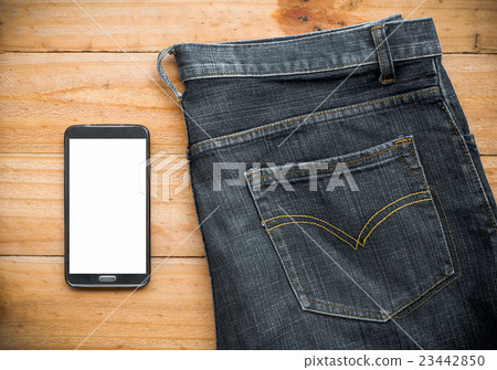 the jeans and mobile phone on wooden board the jeans and mobile phone on wooden board 23442850