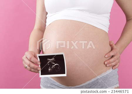 Pregnant woman with an ultrasound picture    23446571
