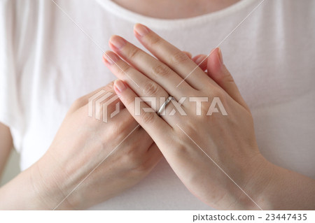 A woman wearing a wedding ring 23447435