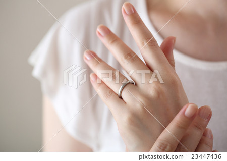 A woman wearing a wedding ring 23447436