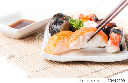 salmon sushi on chopstrick. 23449509