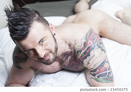 A sexy naked man lay in the bed 23450375