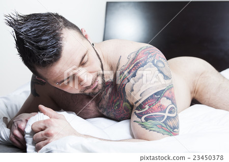 A sexy naked man lay in the bed A sexy naked man lay in the bed 23450378