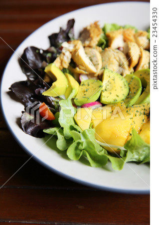 Salad with Chicken avocado and mango on wood background 23454330