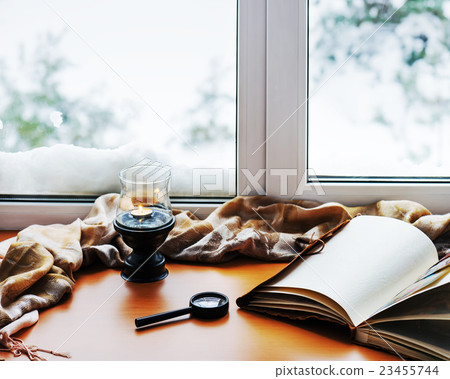 Open photo album, candle, magnifying glass 23455744