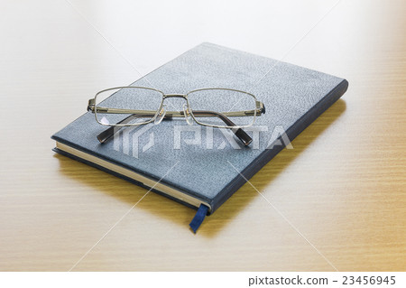 Glasses put on a book Glasses put on a book 23456945
