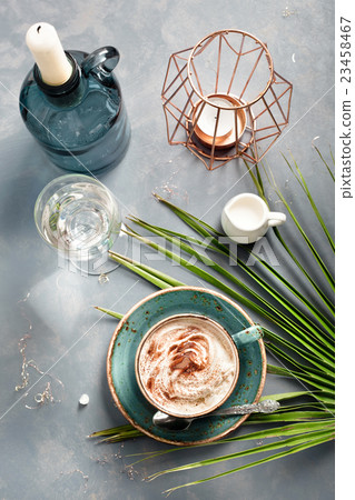 Cup of cappuccino with accessories and palm leaf Cup of cappuccino with accessories and palm leaf 23458467