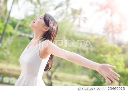 young woman raising her arms 23460923