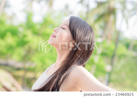 young woman raising her arms 23460925