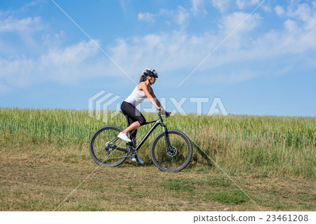 Happy Young Woman riding bicycle outside Happy Young Woman riding bicycle outside 23461208