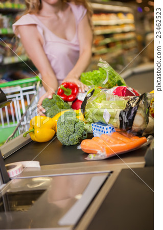 woman buying food at the grocery store woman buying food at the grocery store 23462523